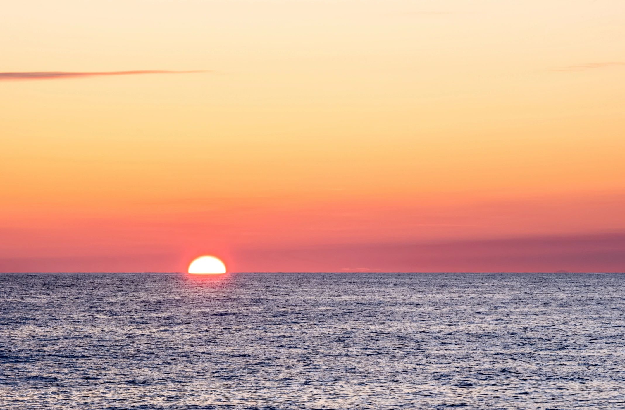 Open ocean sunset representing long-haul cruise holidays