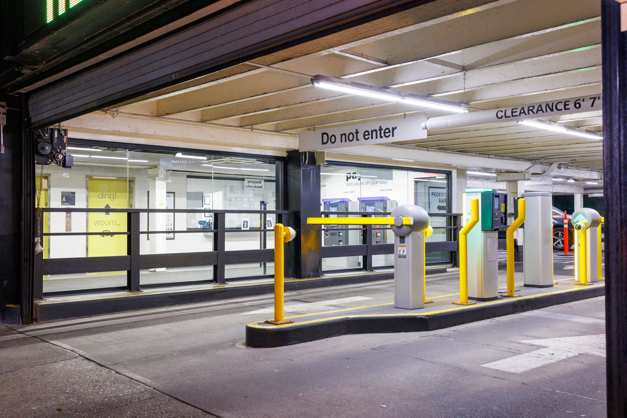 Automated airport-style parking entrance with barrier gate