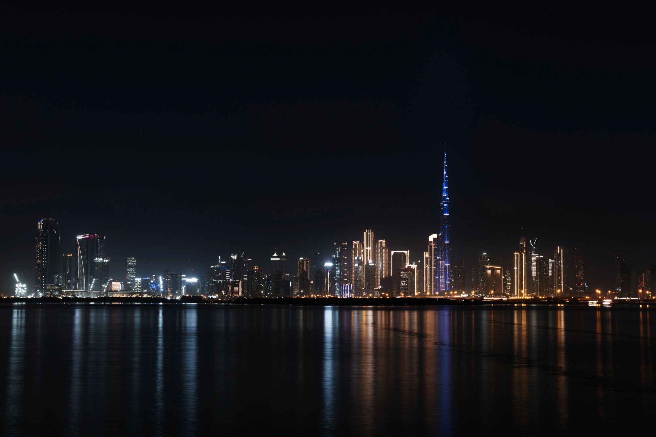 Dubai skyline at night with illuminated skyscrapers