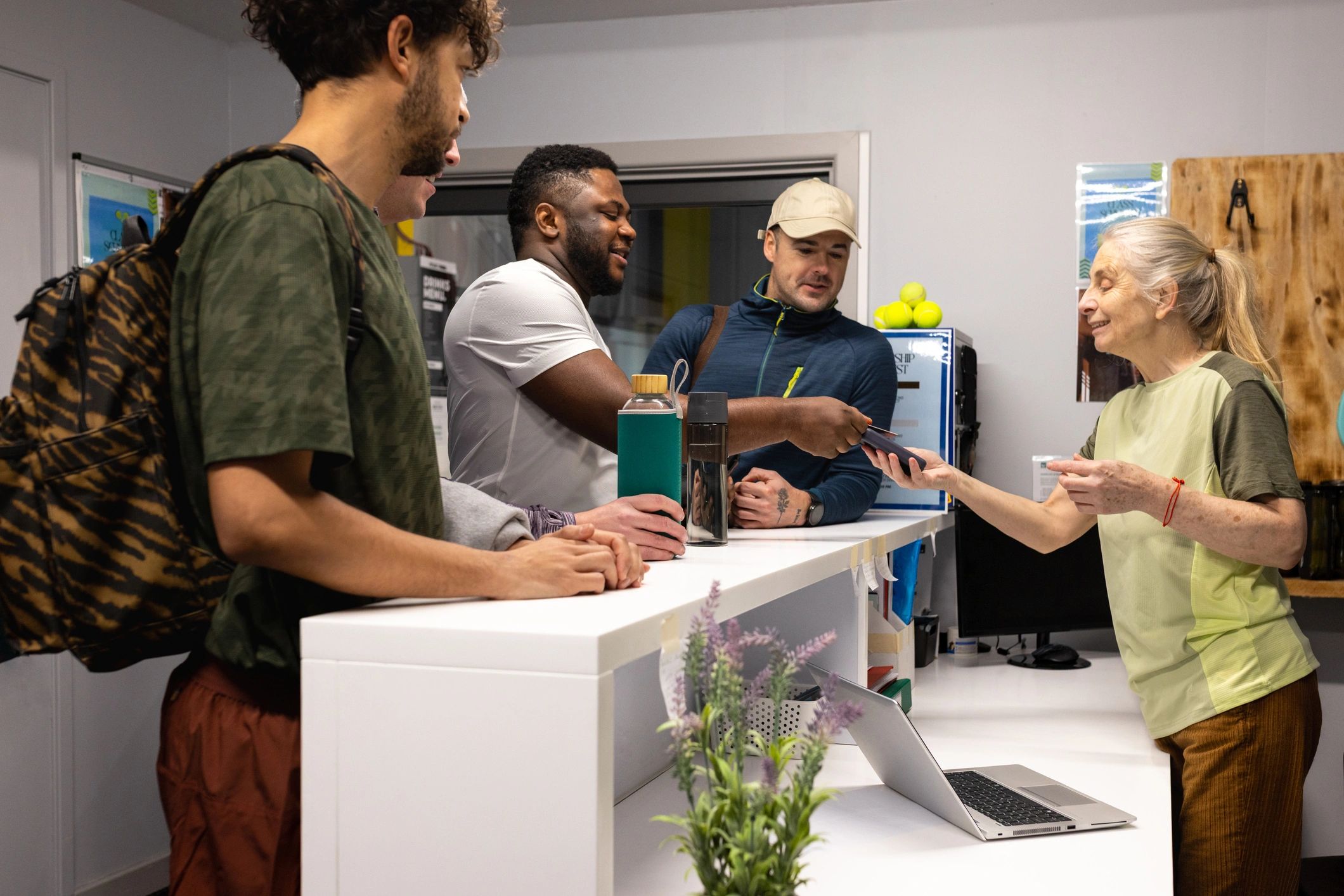 Group receiving friendly assistance at a reception desk
