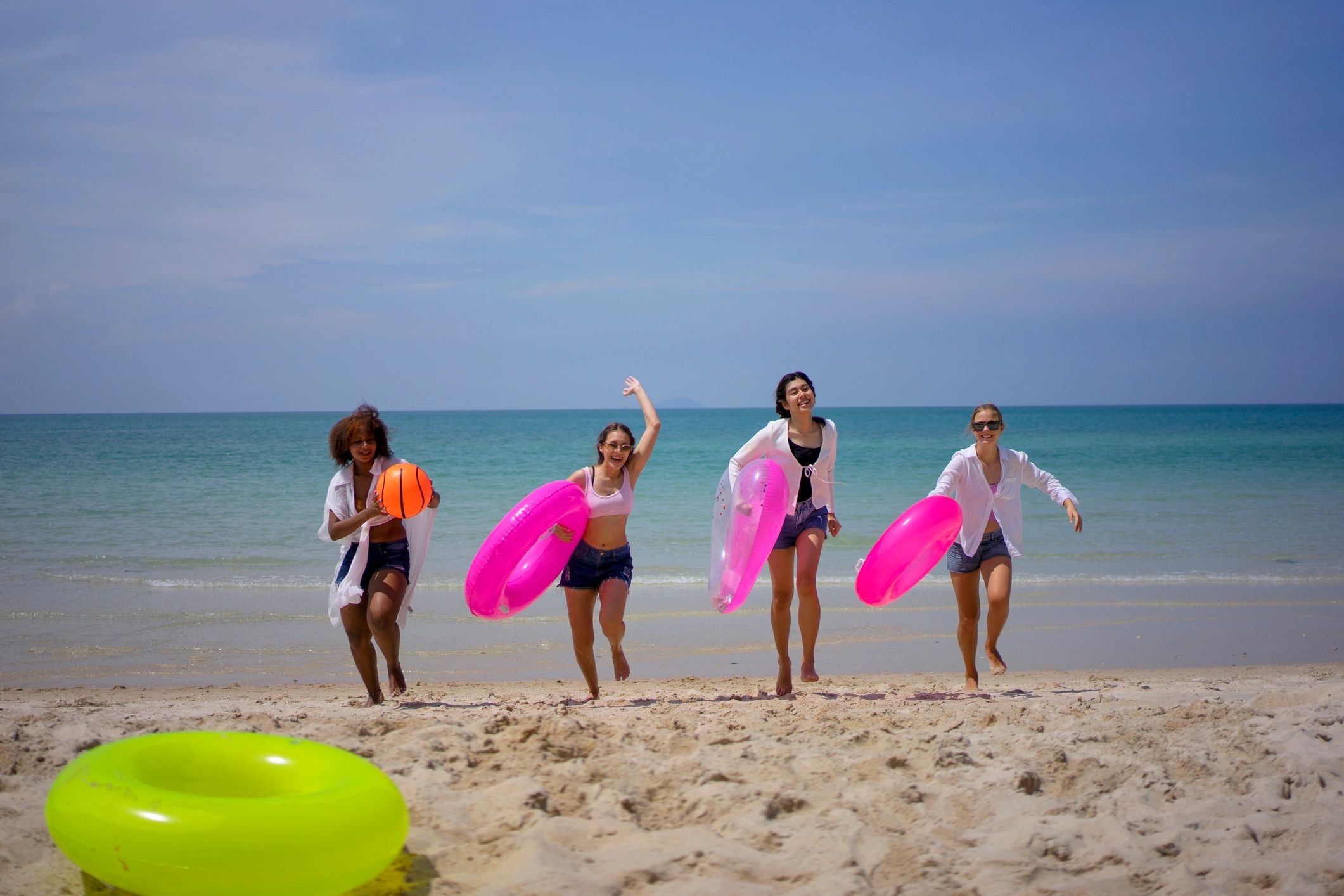 Travellers walking along a beach near an all inclusive resort
