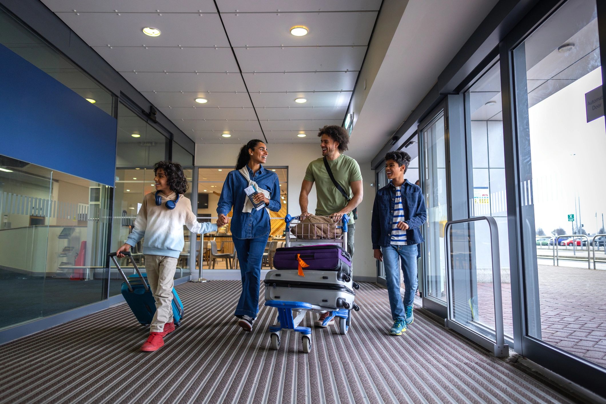Family with children arriving at the airport for a holiday