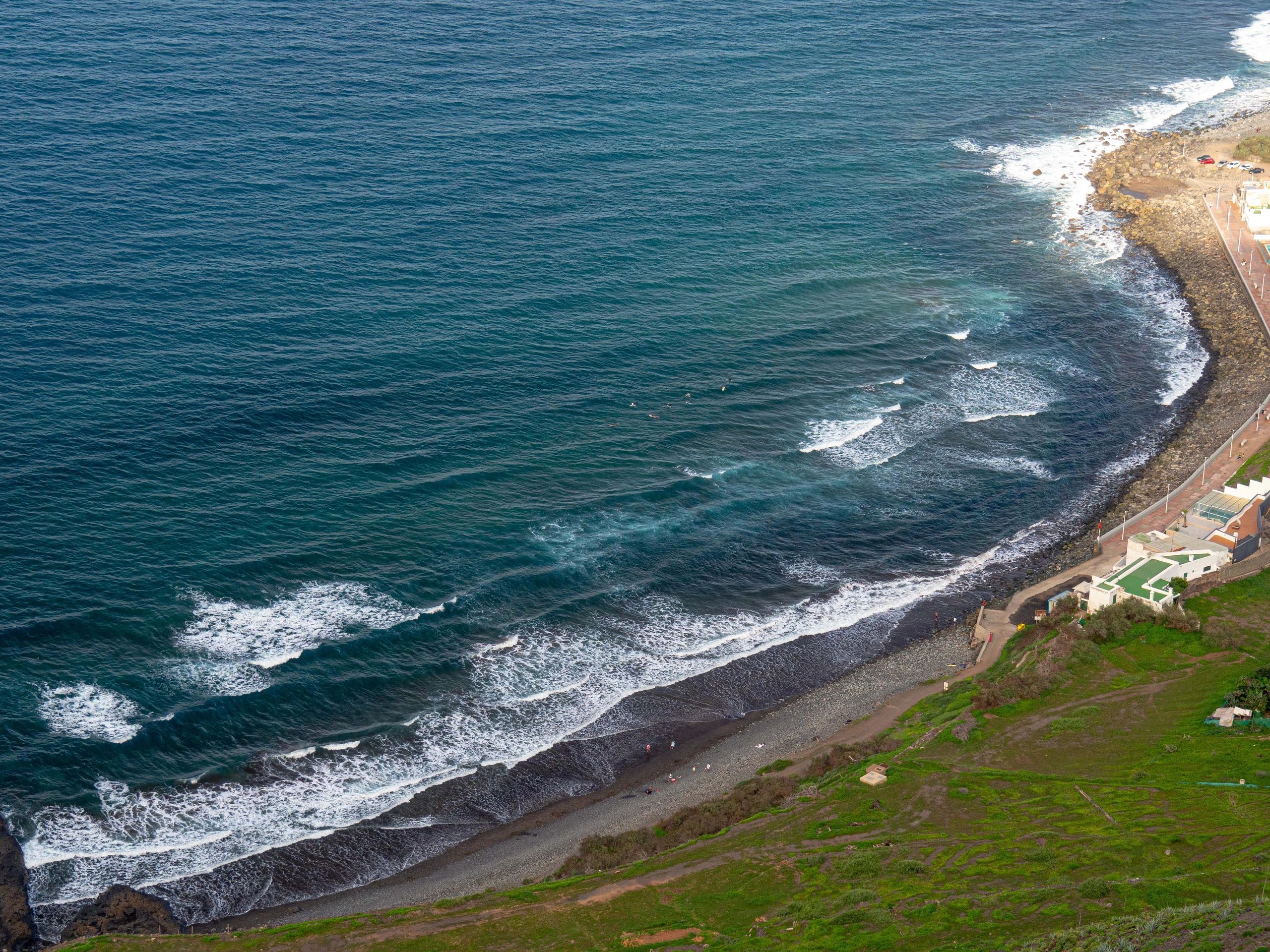 Ocean waves crashing on rocky beach in tenerife